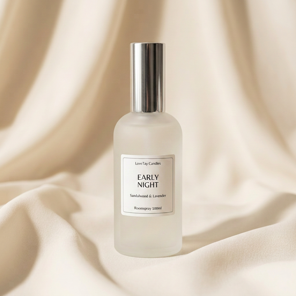 A frosted glass room spray bottle with a metallic silver cap, labeled 'EARLY NIGHT' by Luxe-Tay Candles, set against a draped beige fabric background.