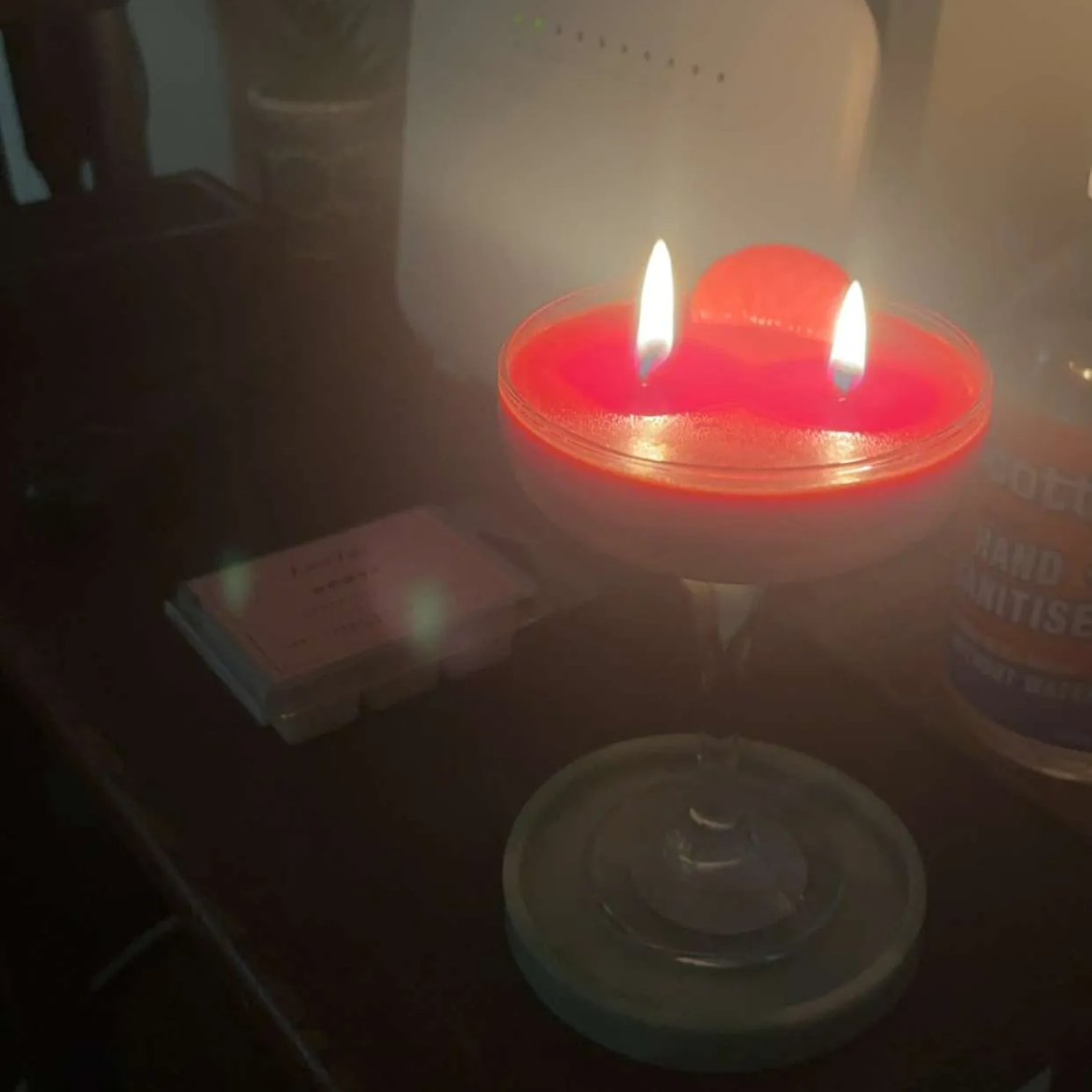 Cocktail Candle from LoveTay Candles sitting on a bench being burnt