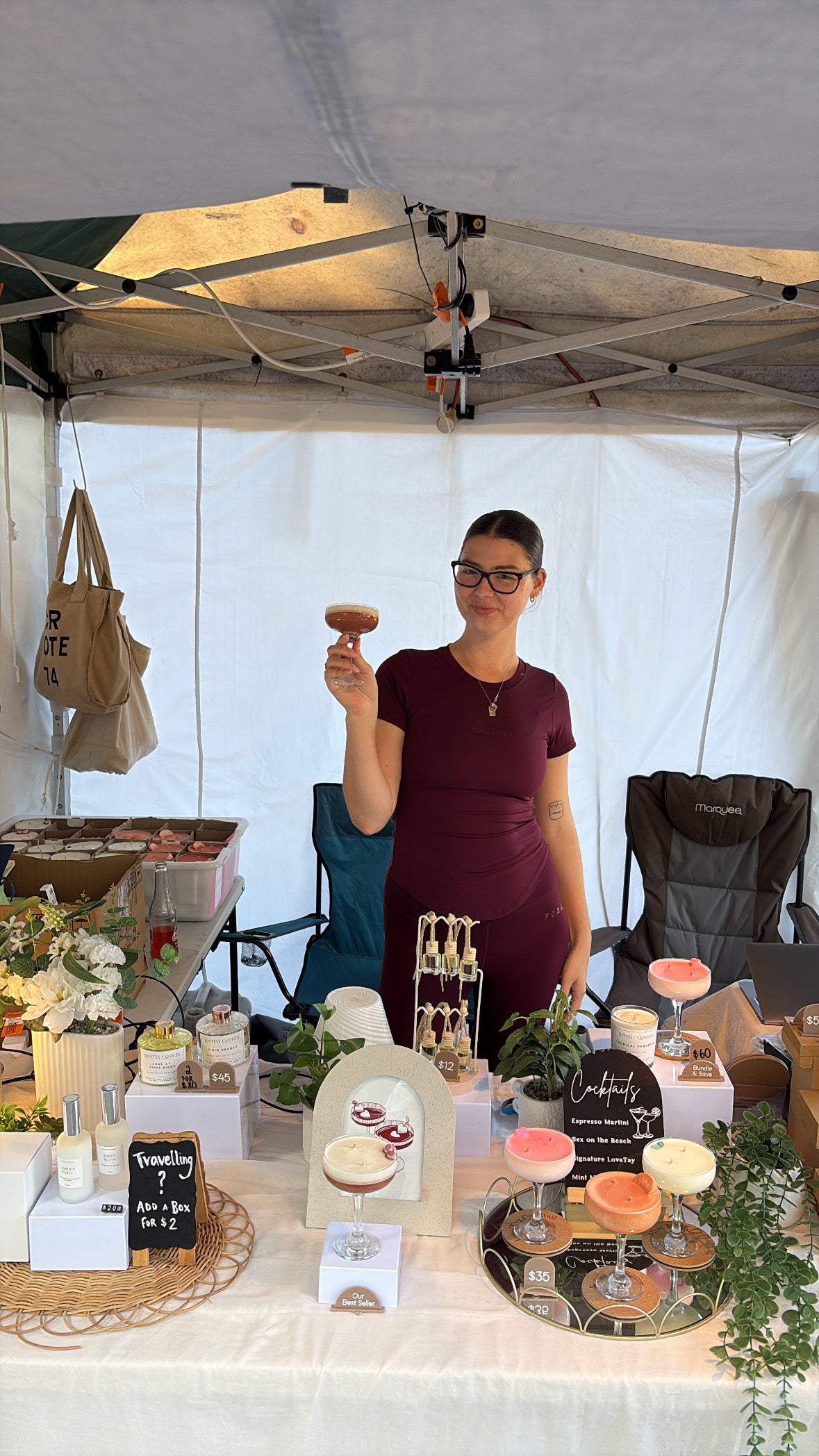 Taylah at the LoveTay Candles Market Stall in Brisbane holding an Espresso Martini Candle from LoveTay Candles